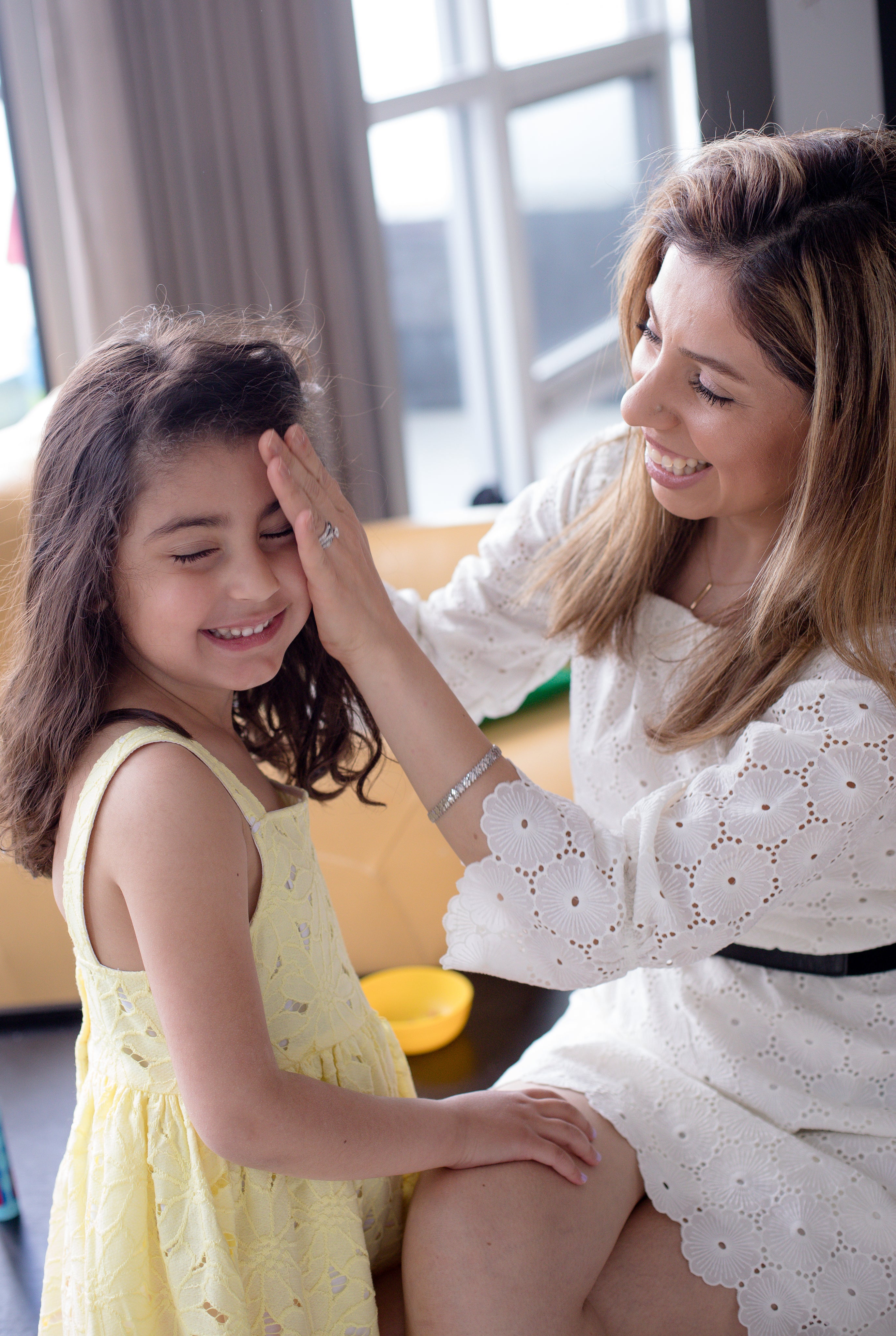 files/woman-sits-and-pulls-the-hair-back-from-a-childs-face.jpg